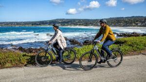 couple riding e bikes along the cost 